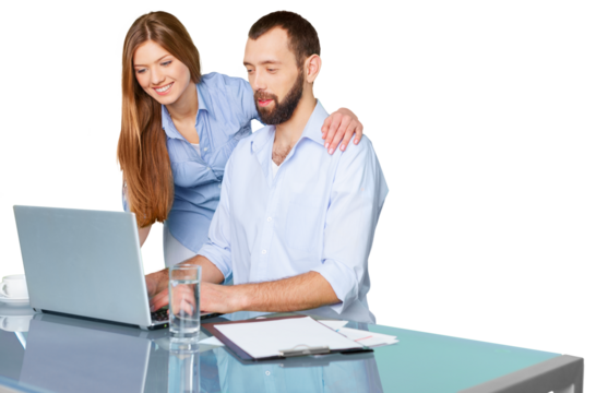 Young Couple Using Laptop On Desk