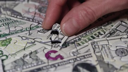 Putting the pieces together.  Financial puzzle pieces.  Slow motion last piece.