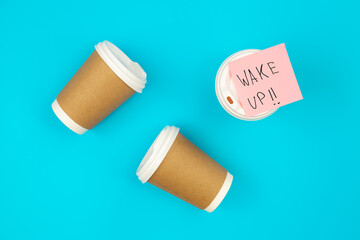 Paper disposable cups and paper reminder with text Wake up.