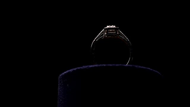 Close-up view of design gold diamond ring in dark on black background