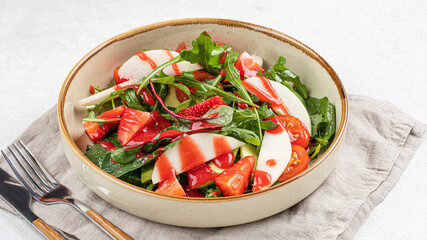Portion of healthy colorful salad with strawberry and greens