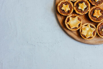 Christmas mince pies with fruit filling on a gray background.
