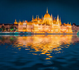 Fototapeta na wymiar Parliament building reflected in the xcalm waters of Danube river. Illuminated summer view of Budapest sity, Hungary, Europe. Traveling concept background.