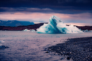 Big icebergs floating in popular tourist destination - Jokulsarlon glacial lagoon. Magnificent summer sunset in Vatnajokull National Park, southeast Iceland. Beauty of nature concept background.