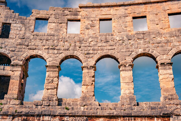 Element of Pula Arena, is known for its ancient Roman structures &ndash; notably the Pula Arena amphitheater against blue sky, Croatia, Europe. Architectural background.