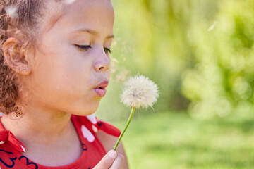 Spring, dandelion and relax with child in park for freedom, youth and growth with mockup space. Nature, summer and flowers with young girl and plant in outdoors for wish, good luck and dream