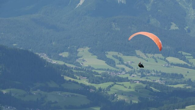 Parasailer soars over Austrian Valley below