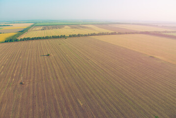 Naklejka premium Amazing view from the height of the balloon. Summer beautiful fields lanscape from the bird's eye, sunrise. Ballooning in Ukraine
