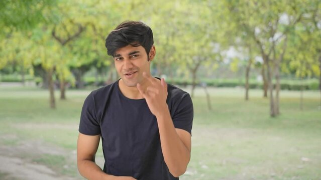 Indian musician beatboxing in a park