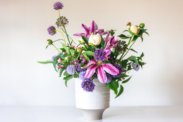 Flowers from a home garden in a vase on a white background.