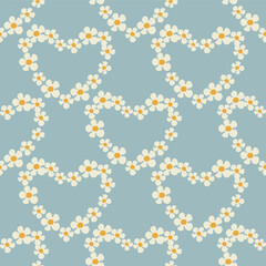 Seamless pattern with heart shape with flowers of daisy flowers in Groovy style on a blue background
