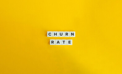 Churn Rate Term on Block Letter Tiles on Yellow Background. Minimal Aesthetic.