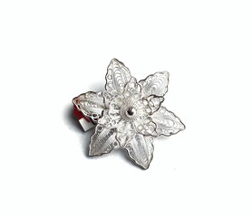 Filigree silver brooch with flower motif isolated on white background.