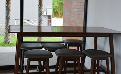At the cafe, there are tables and chairs for customers to sit.