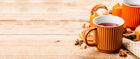 Spicy hot tea. Autumn good mood, traditional fall beverage in cups. Pumpkin, scarf, candles