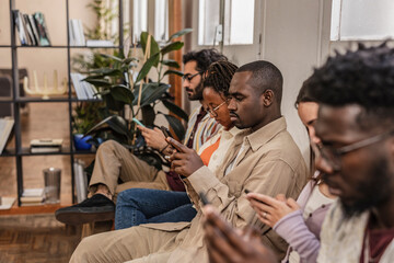Business people, hiring and hands with phone in waiting room for networking, social media or communication at office. Group of employee workers wait in line or row with smartphone on recruitment app