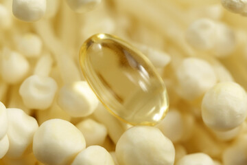Mushroom or enoki close up medical use, dietary supplements, pills capsules. Golden needle mushroom.