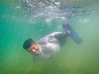 Man diving underwater with mask and snorkel at Cupe beach, PE