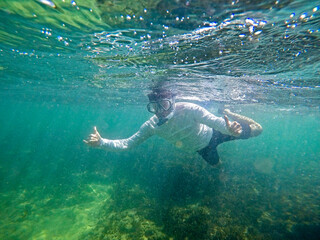 Fototapeta na wymiar Man diving underwater with mask and snorkel at Cupe beach, PE