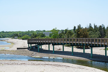 he Mattapoisett Rail Trail, a bike and pedestrian path, crosses a section of beach on a long raised...