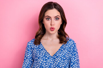 Photo of adorable impressed woman with wavy hairdo dressed blue blouse astonished staring pouted lips isolated on pink color background