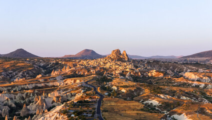 Panoramic aerial view on Uçhisar and ancient castle Uçhisar Kalesi located in Cappadocia, Turkey in sunrise