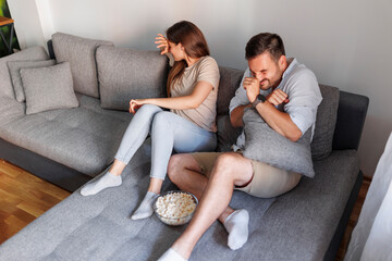 Couple watching scary movie on TV