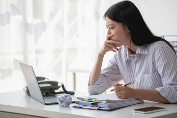 Concept Burnout Syndrome. Asian business Woman feels uncomfortable working. Which is caused by...