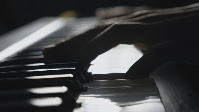 Close up fingers of pianist pressing at the synthesizer keys. Hands of man plays solo of music at synthesizer. Slow motion Side view Isolated shot
