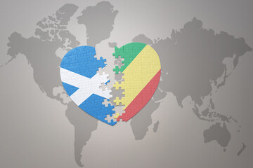 puzzle heart with the national flag of republic of the congo and scotland on a world map background.Concept.