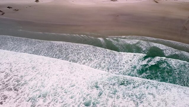 Aerial Drone View Of Foamy Surfing Waves In Playa de Caion In Galicia, Spain.