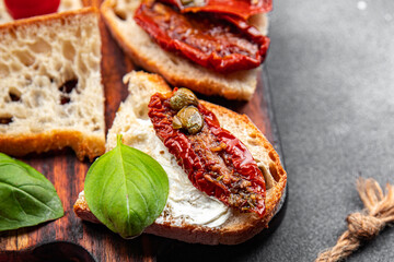 tomato bruschetta aperitif sun-dried snack meal food on the table copy space food background rustic...