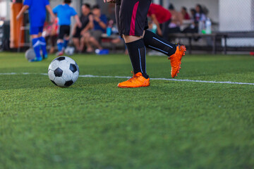 Children playing control soccer ball tactics on grass field with for training