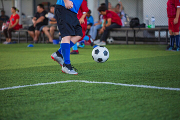 Children playing control soccer ball tactics on grass field with for training