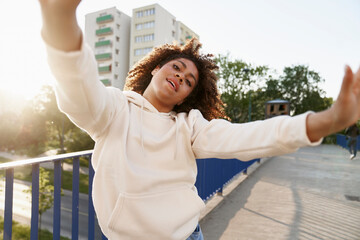 Low angle view of black woman dancing on the bridge