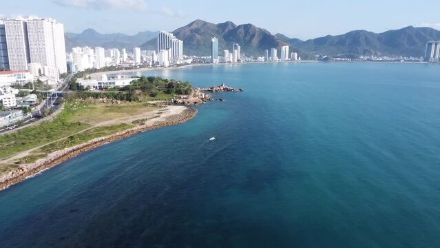 original video without processing, general view, urban landscape, nha trang city in vietnam, filmed from a drone, magnificent asia, beach by the sea, modern city in the tropics, landmark rock garden