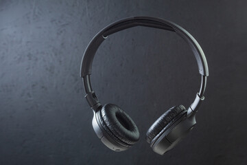 Fototapeta na wymiar Large wireless headphones on a dark background