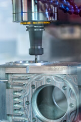 Demonstration of the work of a CNC milling machine drilling a metal part, an example of drilling a boring chamfer of a workpiece in a workshop for the metalworking industry