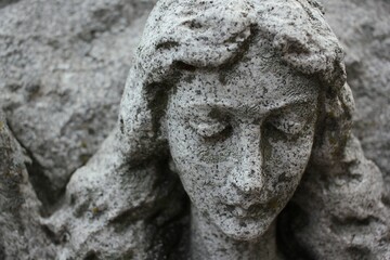 A lovely young woman looking down at the ground.