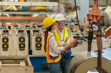 Factory apprenticeship. Man mentor teaching Female employees trainee operating machine looking...