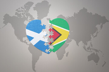 puzzle heart with the national flag of guyana and scotland on a world map background.Concept.