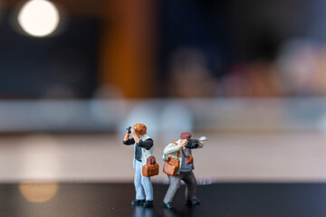 Miniature people Photography holding a camera and copy space for text , World photography day...