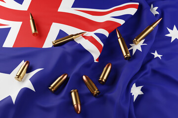 Golden 9mm and 7.62x51mm bullets scattered on the national flag of Australia. Illustration of the concept of Australian gun control policy