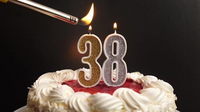 A candle in the form of the number 38, inserted into the holiday cake, is lit. Celebrating a birthday or a landmark event. The climax of the celebration.