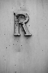 Ancient building detail letter R in black and white.