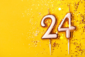 24 years celebration. Greeting banner. Gold candles in the form of number twenty four on yellow...