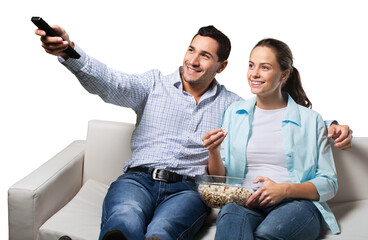Young couple watching tv siting on a sofa