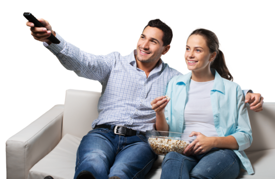 Young couple watching tv siting on a sofa