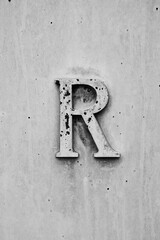 Ancient building detail letter R in black and white.