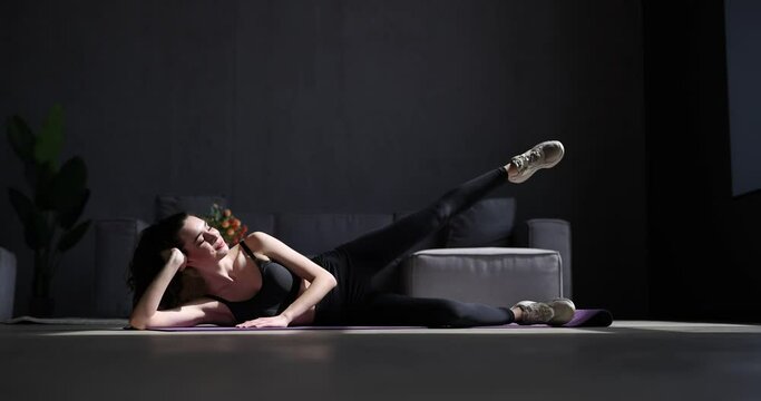 Young woman make leg exercises at home